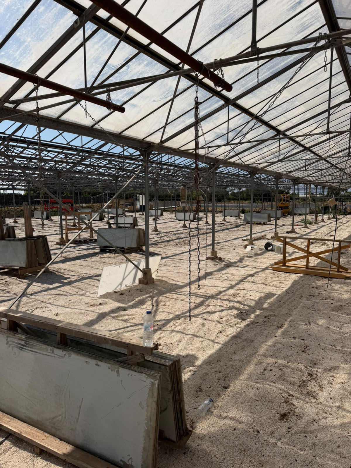 Greenhouse structure in a visible dismantling state.
