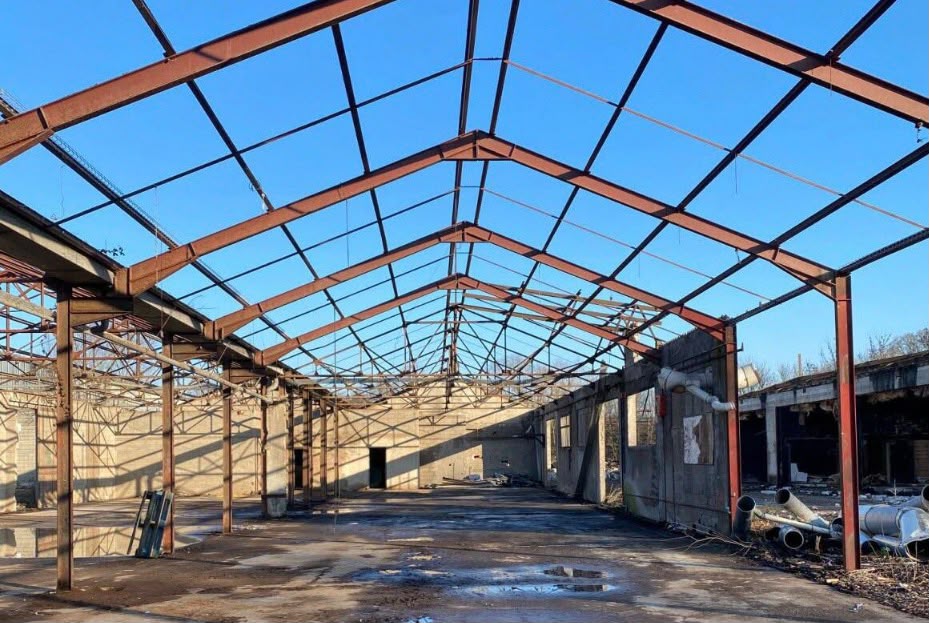 Stripped steel-framed industrial building interior.